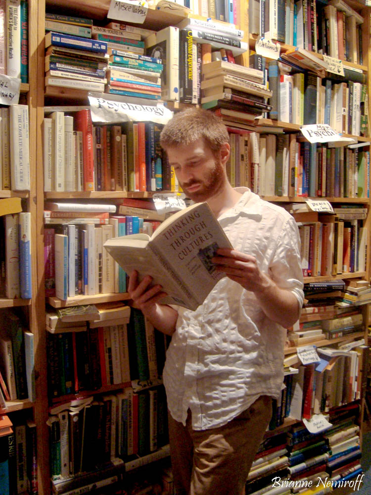 Benjamin Hagerty of It's Bree and Ben reading a book at Capitol Hill Books