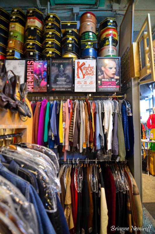 racks of clothes and hat boxes inside of Eons Fashion Antique