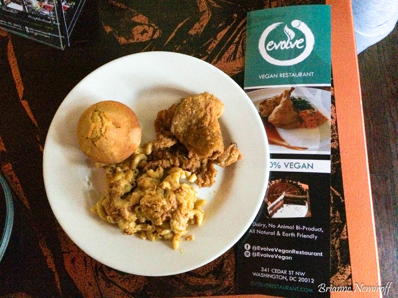 a plate of vegan macaroni and cheese, cornbread muffin, and fried chicken at ELife Retaurant formerly Evolve